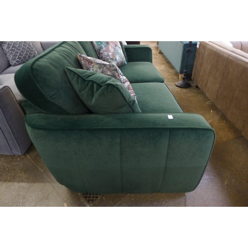 1475 - A deep green velvet three seater sofa