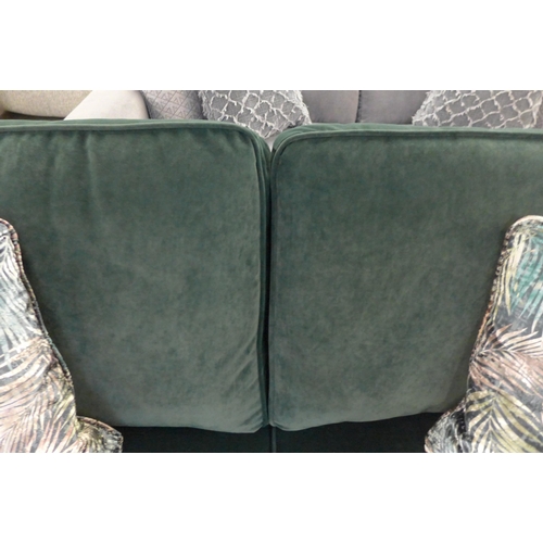 1475 - A deep green velvet three seater sofa