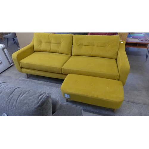 1490 - A turmeric velvet three sater sofa and footstool