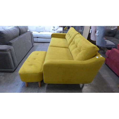 1490 - A turmeric velvet three sater sofa and footstool