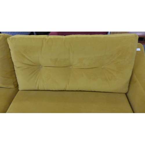 1490 - A turmeric velvet three sater sofa and footstool