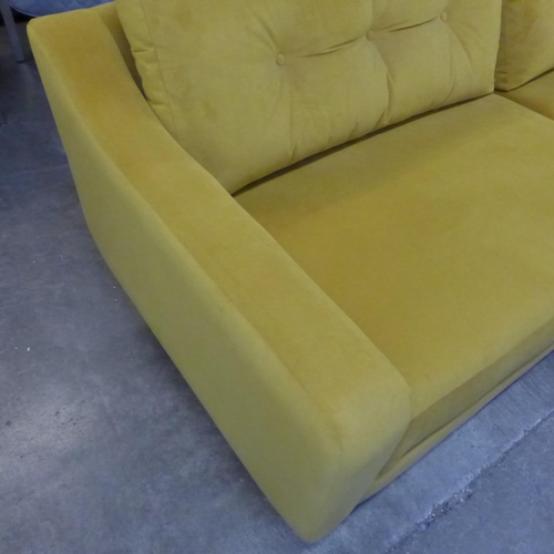 1490 - A turmeric velvet three sater sofa and footstool