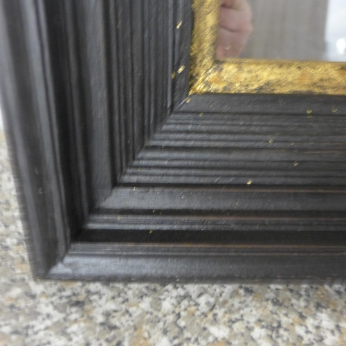 1508 - A black and gold framed mirror