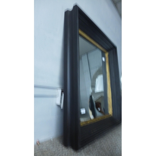 1508 - A black and gold framed mirror