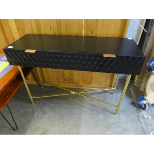 1510 - A black geometric console table with gold legs