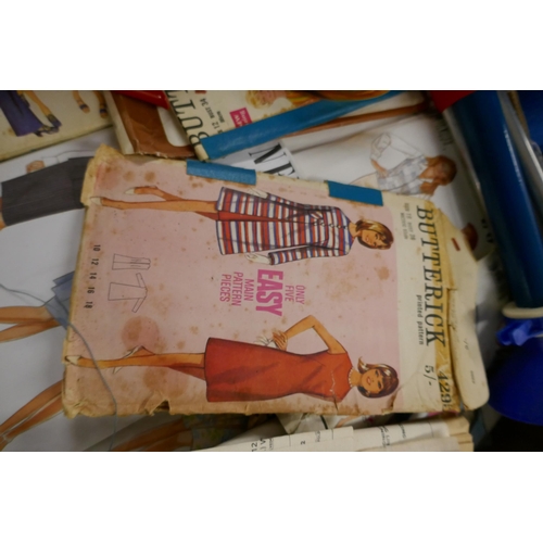 2401 - A dressmaking dummy and a large quantity of patterns