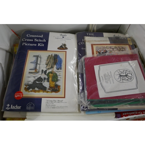 2403 - A box of cross stitch patterns, etc.