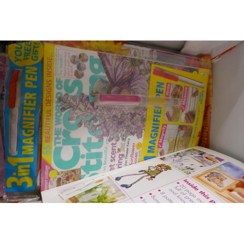 2403 - A box of cross stitch patterns, etc.