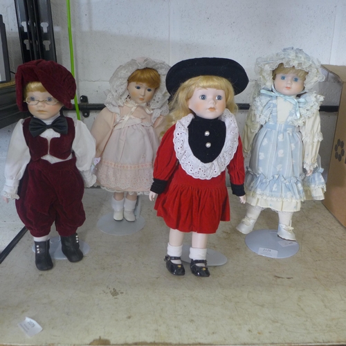 2129 - Four modern china dolls on stands