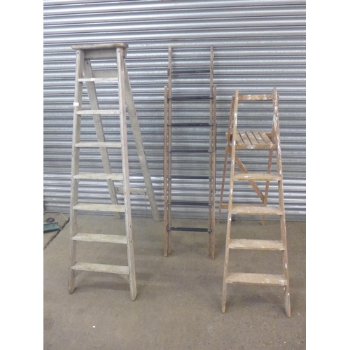 2230 - A set of 5-rung wooden stepladders, a set of 8-rung wooden stepladders and a set of wooden extension... 