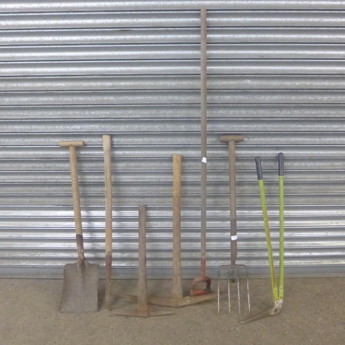 2241 - 7 Garden tools including a pitchfork, pickaxes, shovel, hoe etc