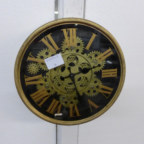 1341 - A gold moving gears wall clock