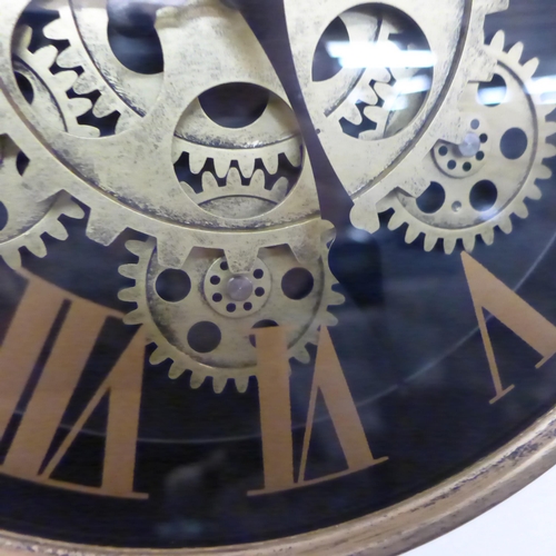 1341 - A gold moving gears wall clock