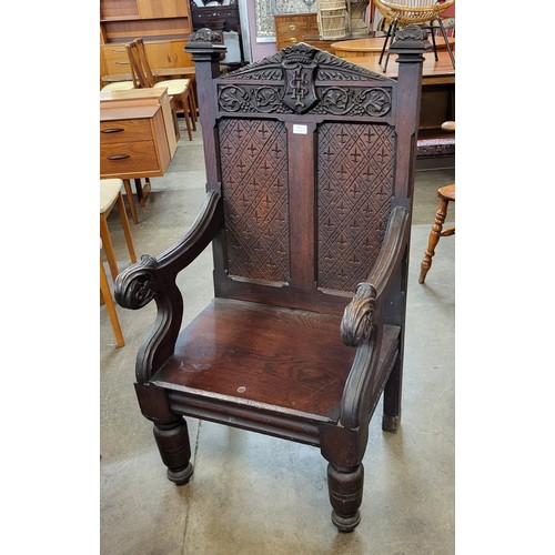 75 - A Victorian Jacobean Revival carved oak Bishops chair