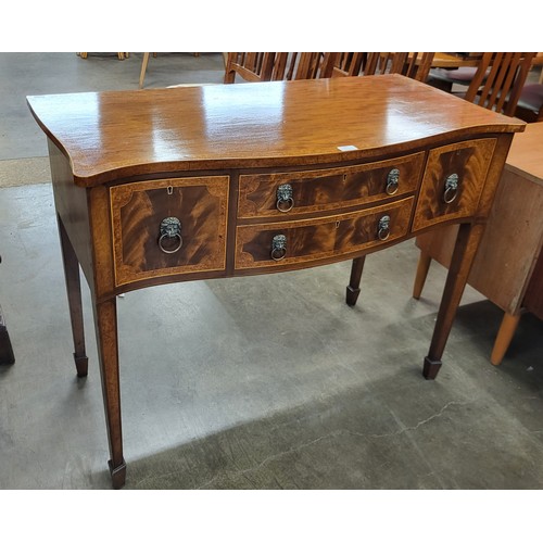 102 - A Regency style inlaid mahogany serpentine sideboard