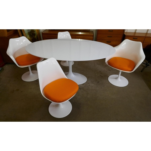 1 - An Eero Saarinen style white laminate tulip oval dining table and four chairs