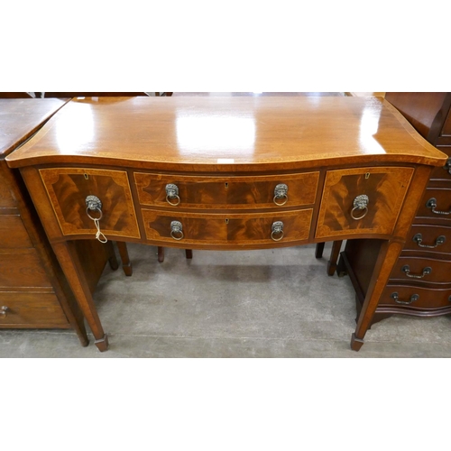 102 - A Regency style inlaid mahogany serpentine sideboard