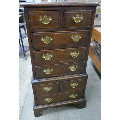 107 - A small George III style oak chest on chest