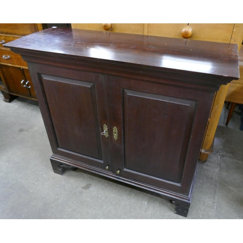 110 - A George II mahogany two door fitted cupboard