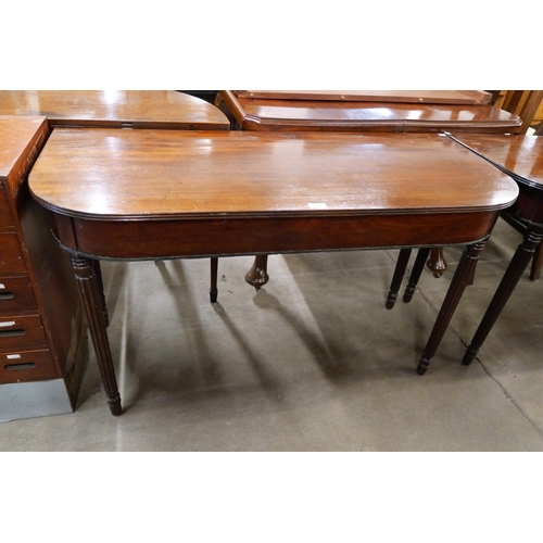 152 - A pair of Regency mahogany demi lune console tables