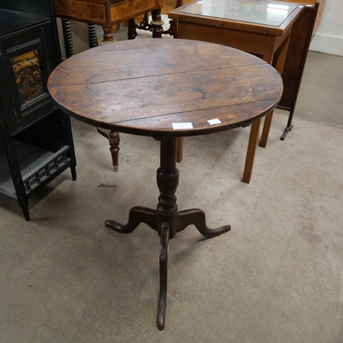 155 - A George III oak circular tilt top tripod tea table