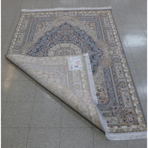 158 - An Iranian beige ground rug, 242cm x 162cm