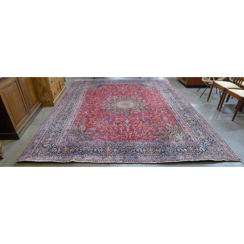 159 - A large Persian Tabriz red ground carpet, 388 x 384cms