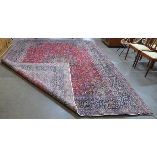 159 - A large Persian Tabriz red ground carpet, 388 x 384cms