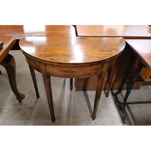 175 - A George III inlaid mahogany demi lune fold over tea table