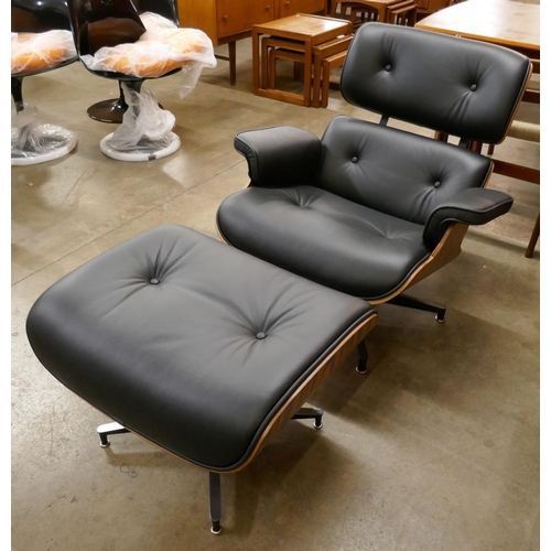 2 - A Charles & Ray Eames style black leather and simulated rosewood revolving lounge chair and ottoman