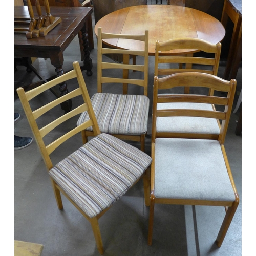 217 - A teak drop-leaf table and two pairs of chairs