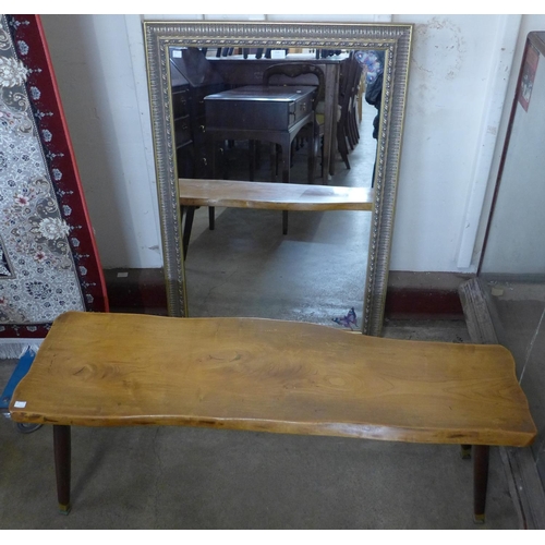 219 - A root wood coffee table and a parcel gilt framed mirror