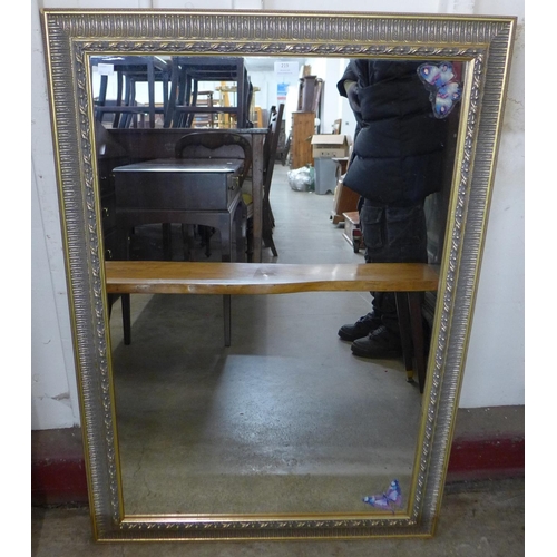 219 - A root wood coffee table and a parcel gilt framed mirror