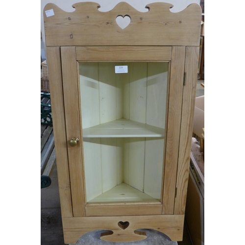 226 - An Arts and Crafts pine wall hanging corner cabinet