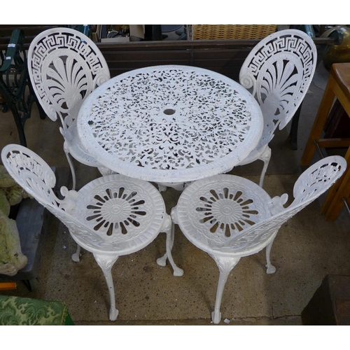 227 - A painted cast alloy garden table and four chairs