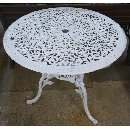 227 - A painted cast alloy garden table and four chairs