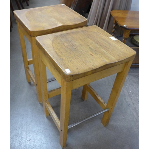 231 - A pair of beech laboratory stools