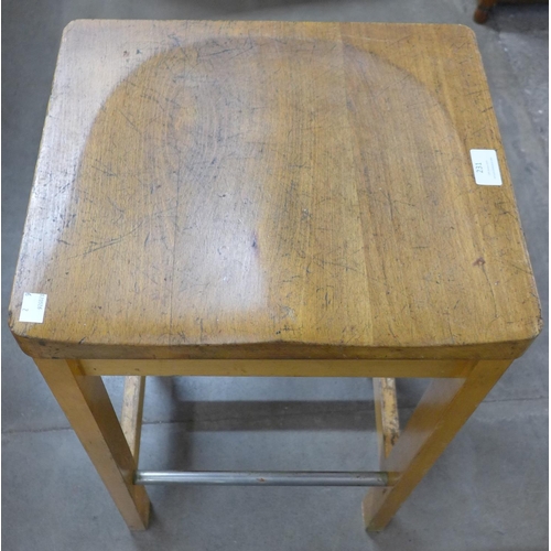 231 - A pair of beech laboratory stools