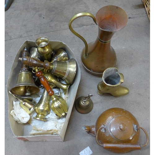 243 - Assorted metalware, including two hammered copper chargers, a small kettle, jugs, brass hand bells, ... 