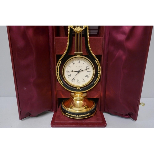 277 - A Swiss Jean Roulet Le Locle brass lyre mantel timepiece, cased