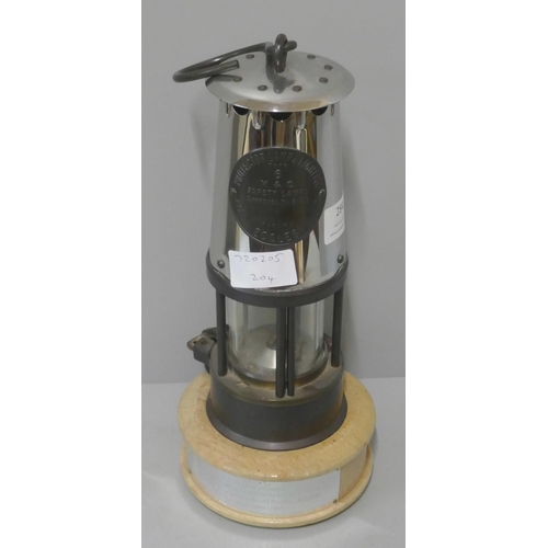 284 - An Eccles Type 6 miners safety lamp, with presentation stand to Sir Gordon Hobday, 1985