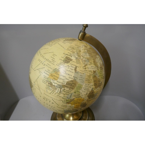 294 - A desk top terrestrial globe, on brass stand