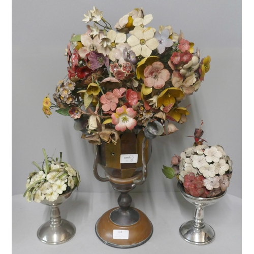 304 - A brass and copper vase and a pair of smaller vases each with painted tin plate flowers