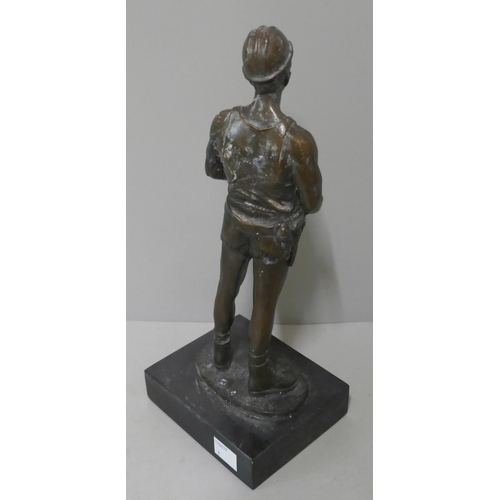 311 - A bronze figure of a miner, on black marble socle