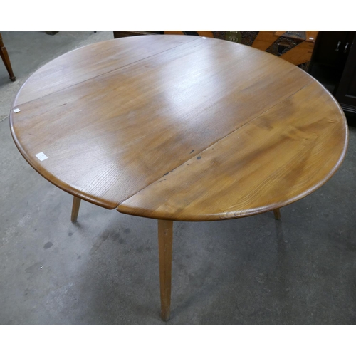 36 - An Ercol elm and beech Windsor drop-leaf dining table