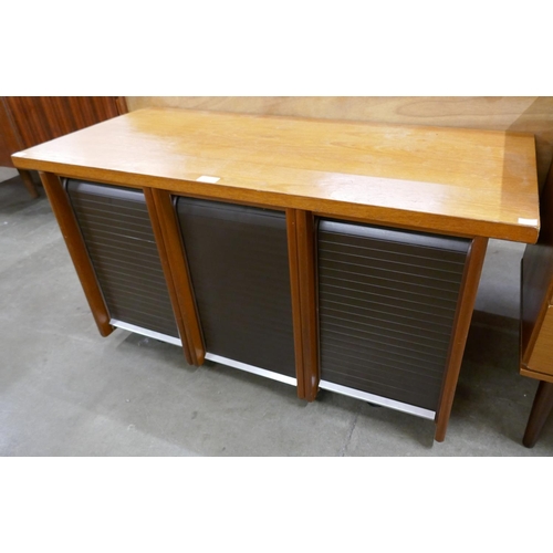 57 - A teak tambour front office cabinet