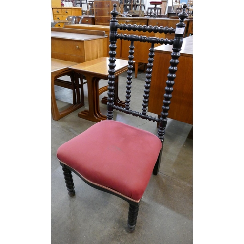 76 - An Arts and Crafts ebonised beech bobbin turned fireside chair