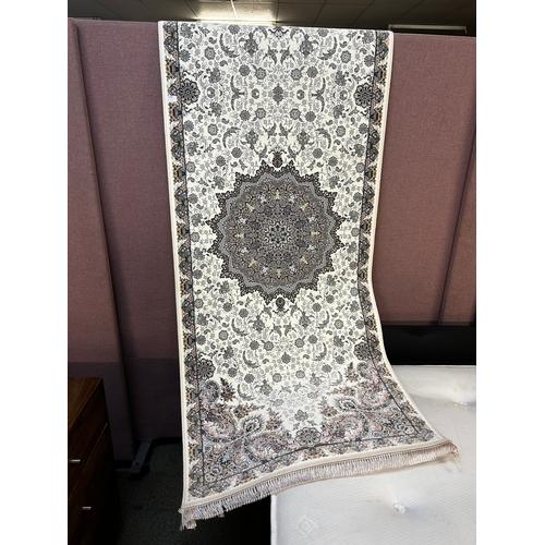 1558 - An ivory ground fine woven iranian runner, embossed floral medallion design, 300cm x 80cm