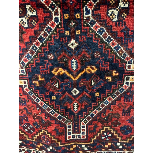 1564 - A rich red ground Persian kashkai Nomadic rug, traditional design, 187cm x 144cm