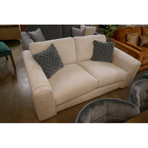 1349 - An ivory upholstered three seater sofa RRP £1099